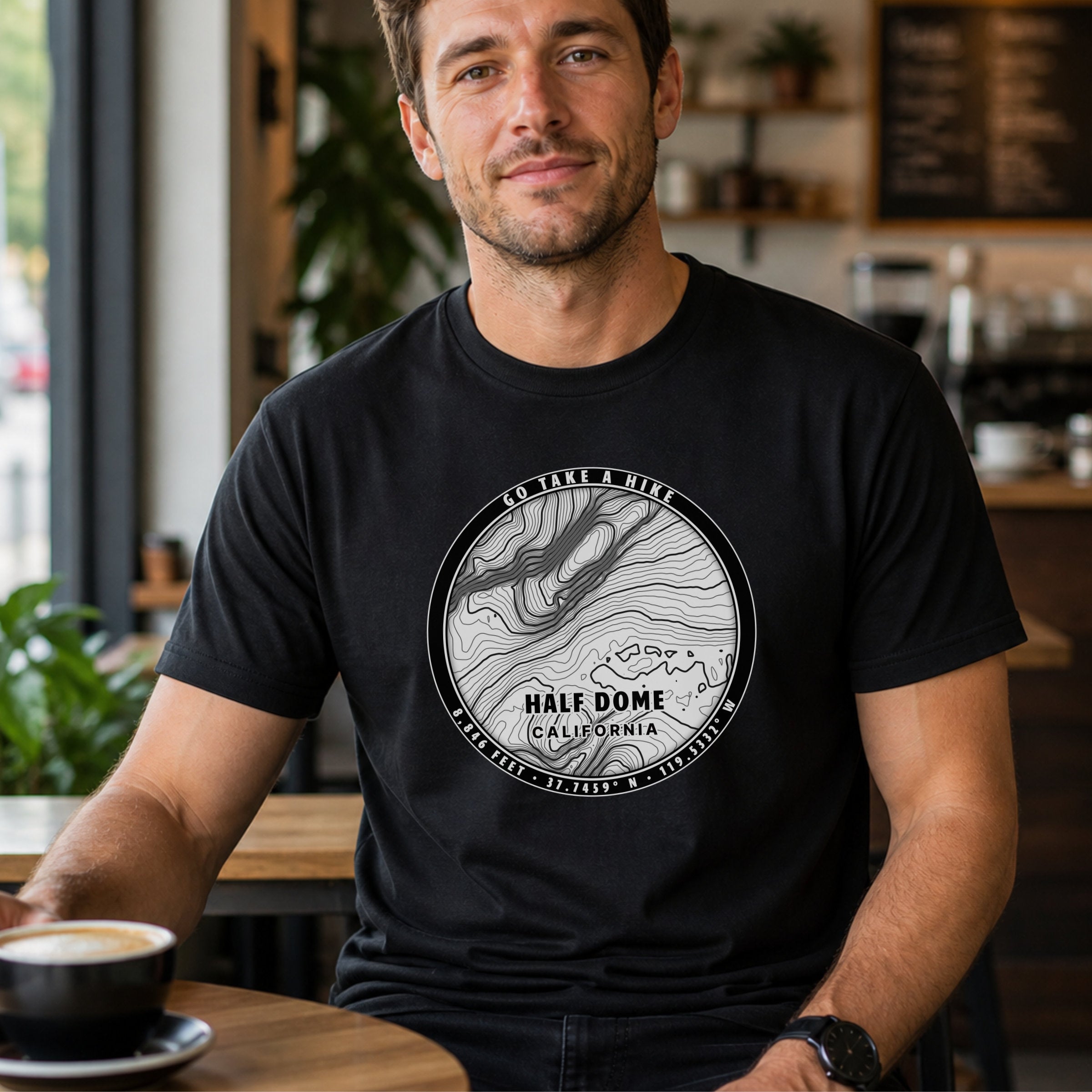 Man indoors wearing black t-shirt with circular contour design